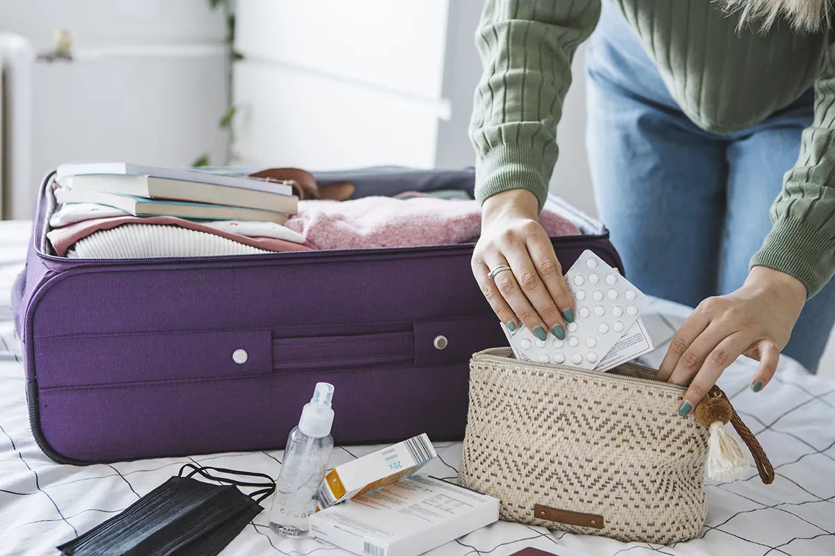 Woman packing drugs for travel